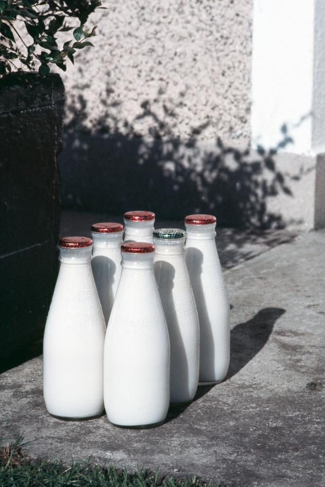 Milk bottles on doorstep, Ireland, 1970s.