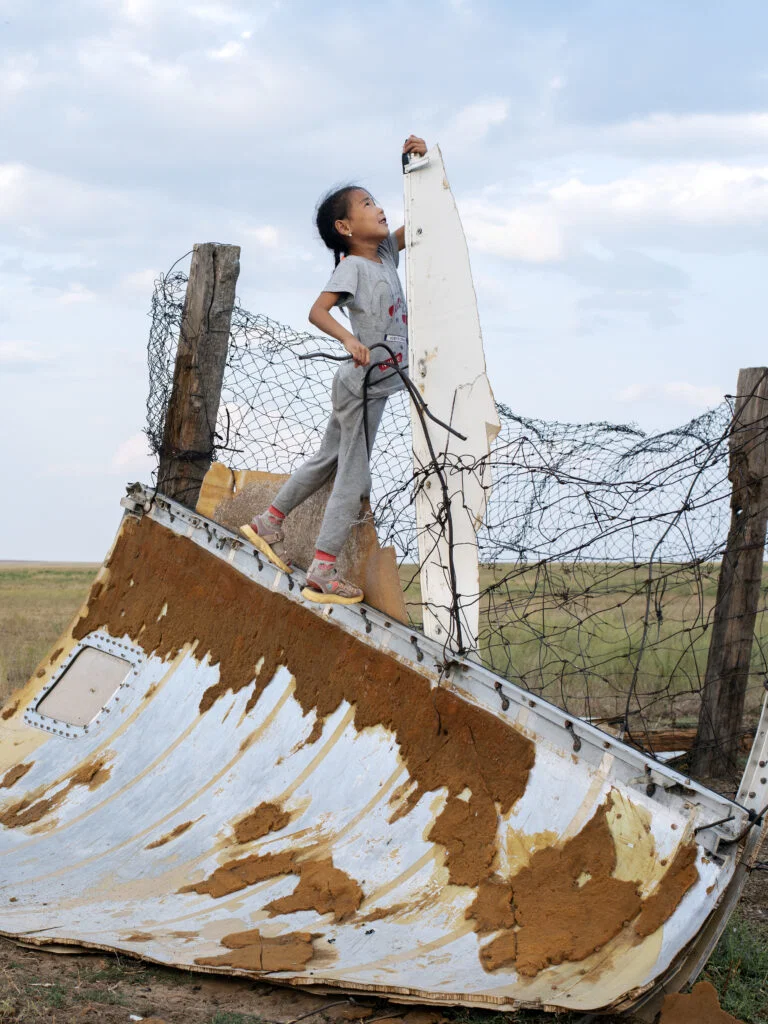 Bagnur-plays-on-space-junk-near-her-home-in-Kenjebai-Samai-Kazakhstan-2022-768x1024